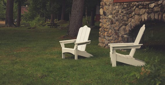 Outdoor chairs on lawn in backyard Money tight? Take a staycation
