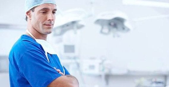 Doctor standing with folded arms COVID-19 lessons can improve health, legal systems