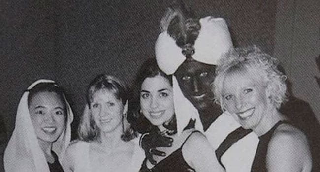 Justin Trudeau in blackface with hand splayed across woman's chest